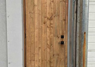 Custom outdoor wooden door designed and installed by Berner Landscape